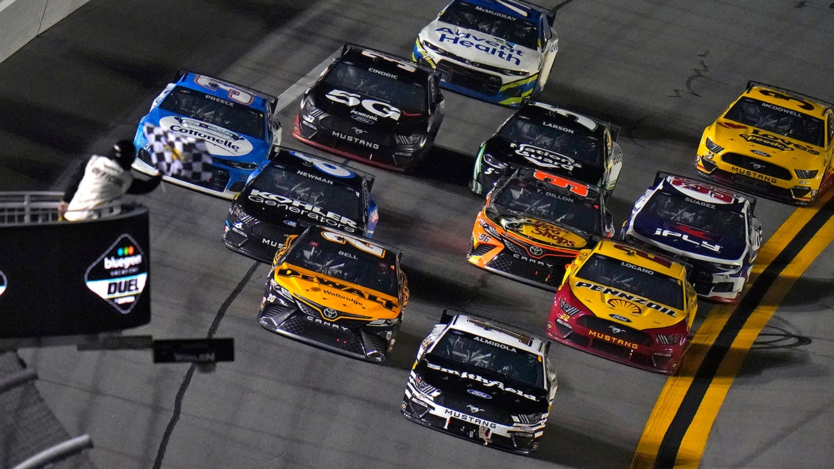 Aric Almirola (10) beats Christopher Bell (20), Ryan Newman (6) and Joey Logano (22) to the finish line to win the first NASCAR Daytona 500 duel qualifying auto race.