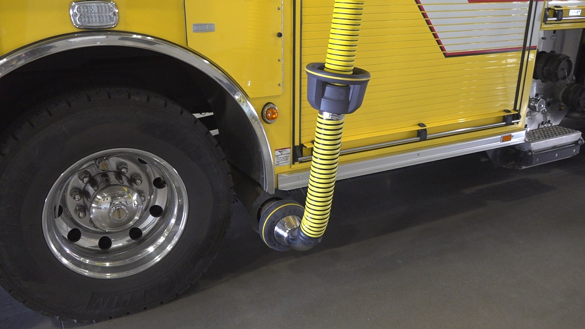 The Goodyear Fire Department has a bright yellow hose hooked up to their fire trucks exhaust, which will then redirect the harmful fumes up and out of the station.