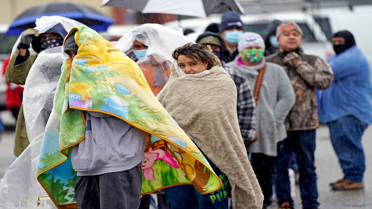 People wait in line to fill propane tanks on Wednesday in Houston. (AP)