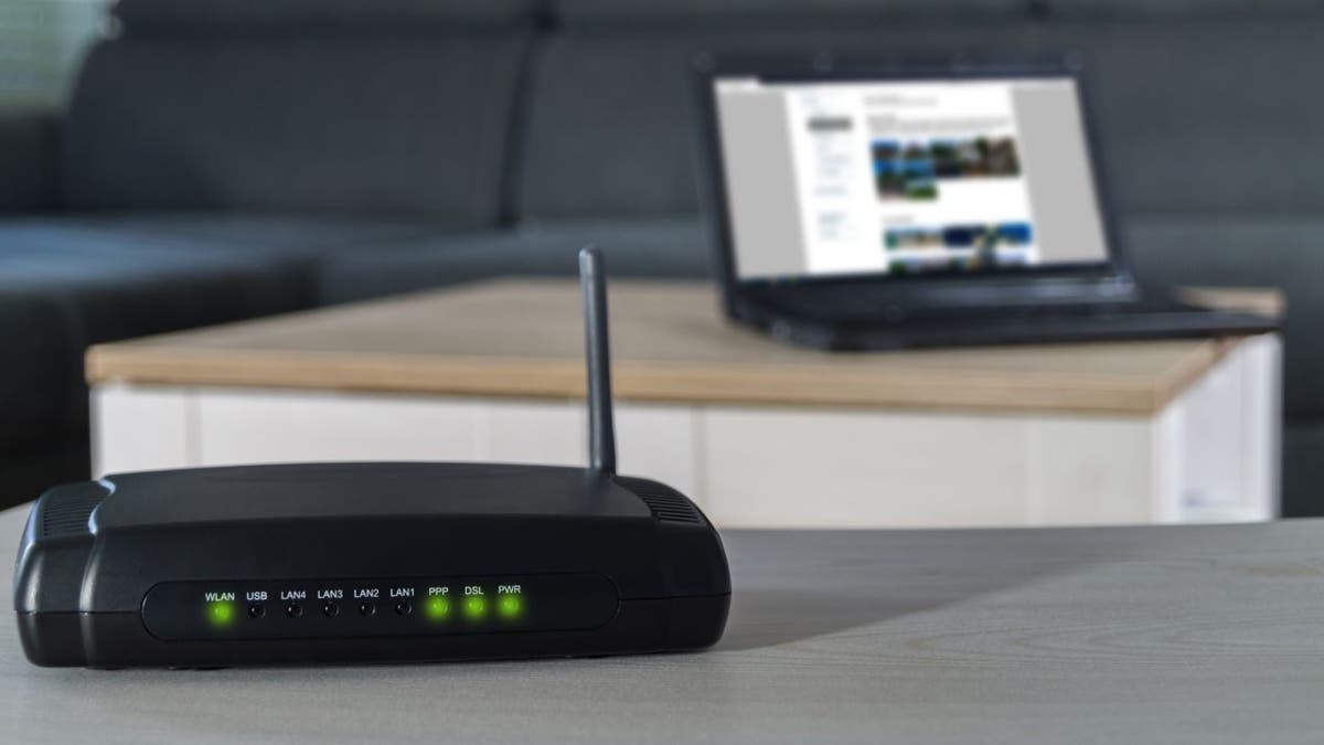 A wlan router on desk with notbook in background