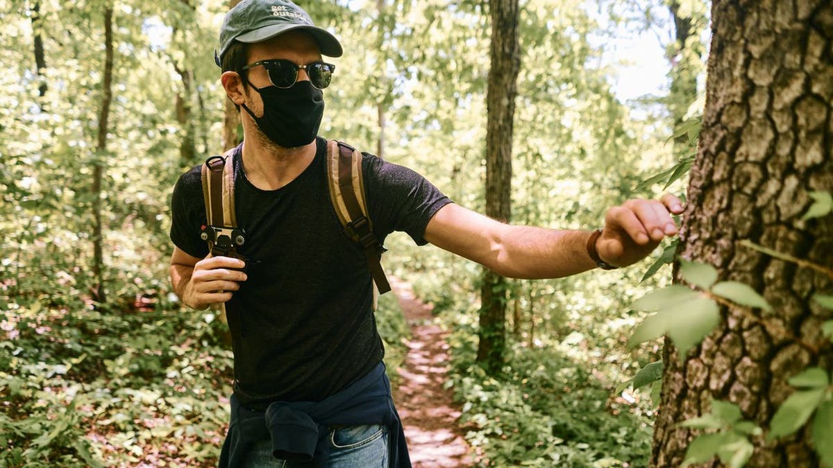 Pictured here is a man wearing a face mask during a hike at a national park in Ozark, Ark. The National Park Service has made masks mandatory due to the coronavirus pandemic. (iStock)