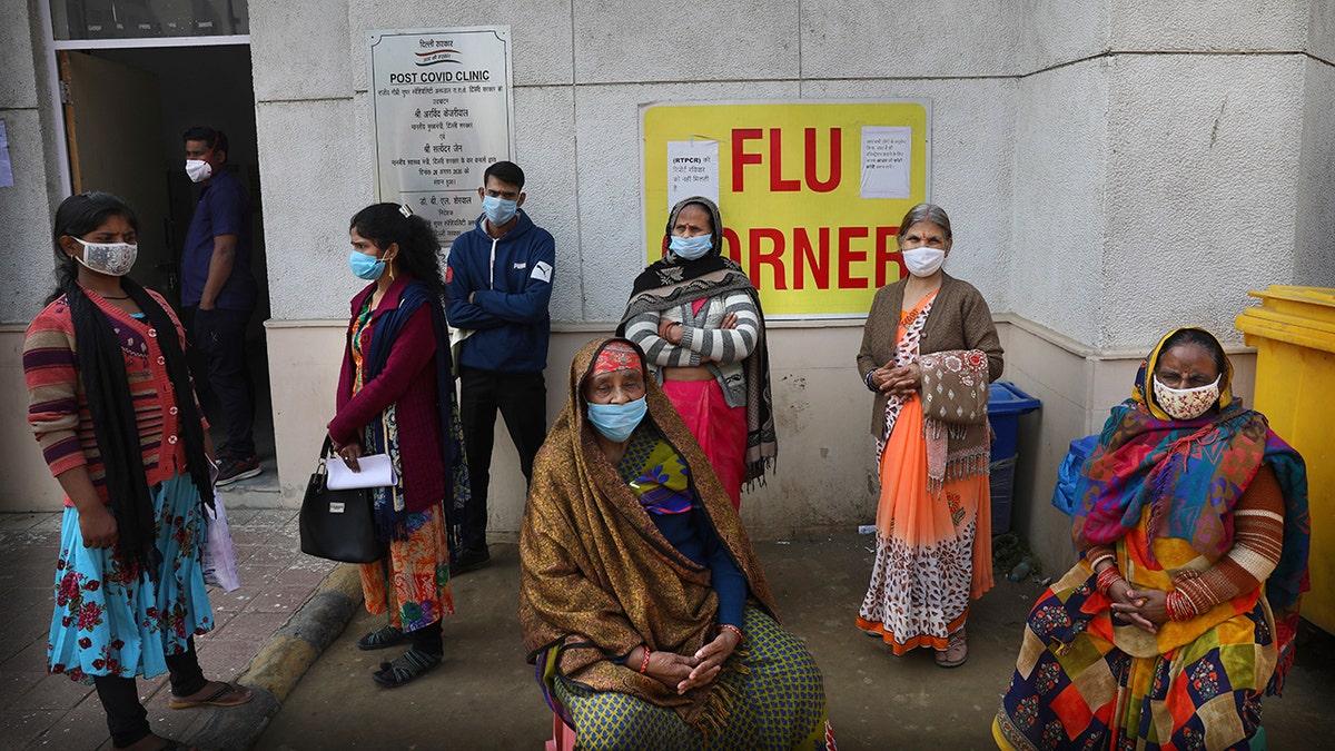 People wait outside a health center to get tested for COVID-19 in New Delhi, India, Thursday, Feb. 11, 2021. (Associated Press)