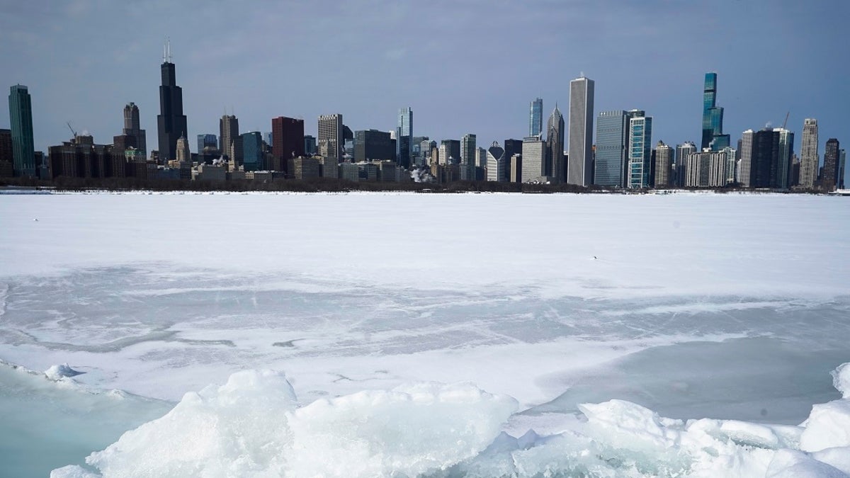 Lake Michigan is shown here Sunday covered with snow and ice, with the Chicago skyline in the background. The area is expected to get more than a foot of snow by the end of Tuesday. (AP)