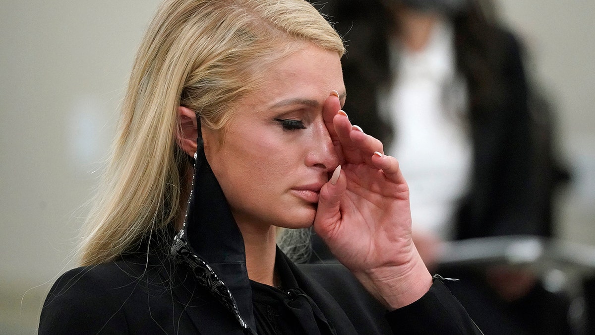Paris Hilton wipes her eyes after speaking at a committee hearing at the Utah State Capitol, Monday, Feb. 8, 2021, in Salt Lake City.