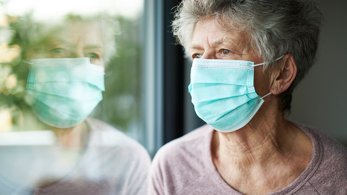 Old woman wears face mask