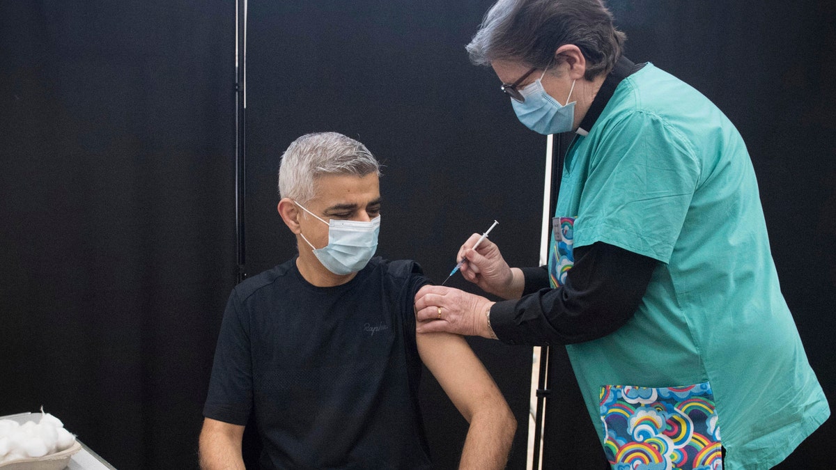 Mayor of London Sadiq Khan receives his first dose of the Pfizer coronavirus vaccine administered by Dr. Sue Clarke at a COVID-19 vaccination clinic at the Mitcham Lane Baptist Church in south London, Friday Feb. 19, 2021. (Stefan Rousseau/PA via AP)