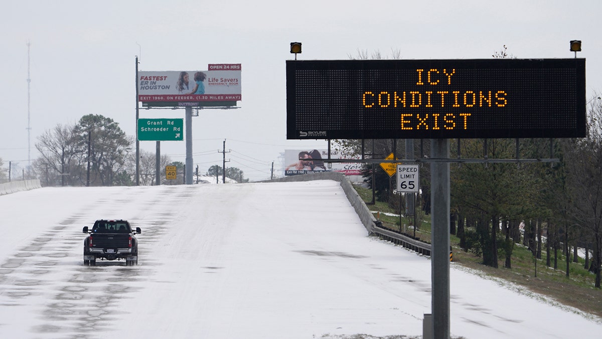 A truck drives past a highway sign Monday, Feb. 15, 2021, in Houston. 