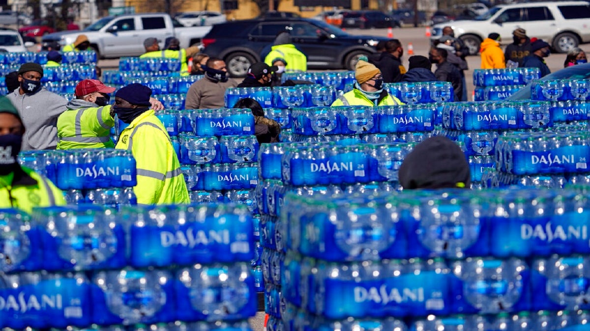 Water to be loaded into vehicles is stacked at a City of Houston water distribution site on Friday. (AP)