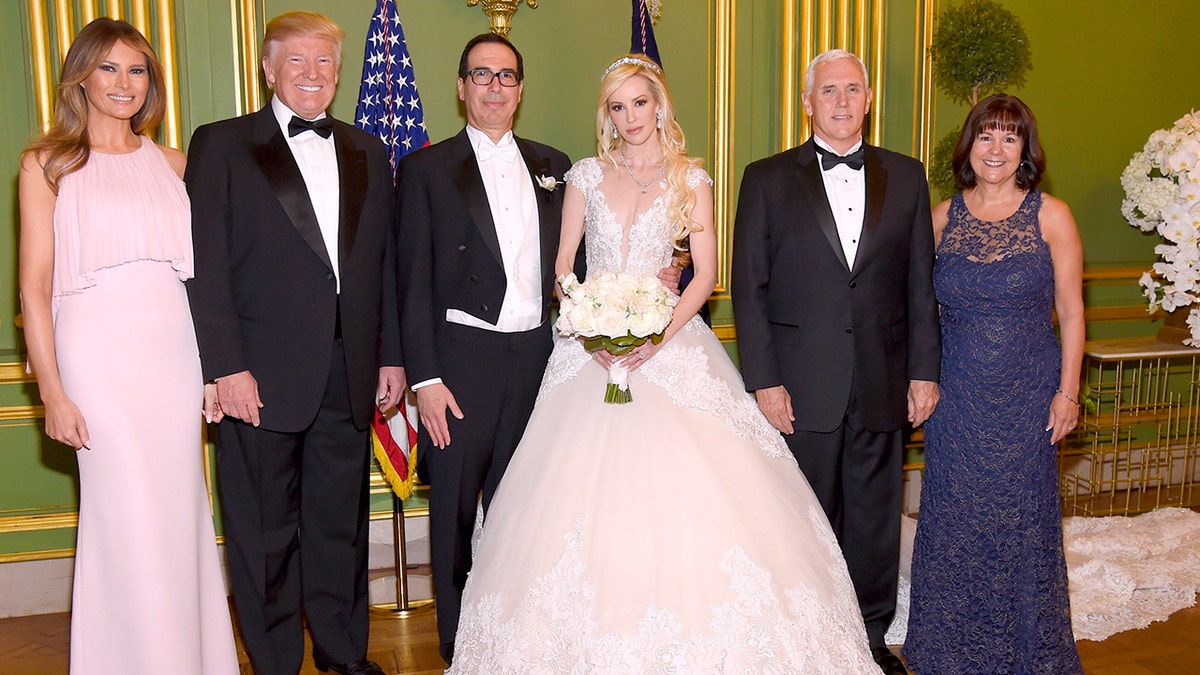 From left to right, first lady Melania Trump, President Donald Trump, Secretary of the Treasury Steven Mnuchin, Louise Linton, Vice President Mke Pence and second lady Karen Pence pose at the wedding of Mnuchin and Linton on June 24, 2017.