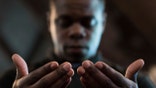 FILE - In this Monday, July 11, 2016 file photo, Paul Bronson prays during a Black Lives Matter prayer vigil at First Baptist Church, a predominantly African-American congregation, in Macon, Ga. According to a Pew study released on Tuesday, Feb. 16, 2021, Black Americans attend church more regularly than Americans overall, and pray more often. Most of them attend churches that are predominantly Black -- yet many would like those congregations to become racially diverse. (AP Photo/Branden Camp)