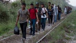 Migrants walk on train tracks on their journey from Central America to the U.S. border., in Palenque, Chiapas state, Mexico, Wednesday, Feb. 10, 2021. President Joe Biden's administration has taken steps toward rolling back some of the harshest policies of ex-President Donald Trump, but a policy remains allowing U.S. border officials to immediately send back almost anyone due to the new coronavirus pandemic. (AP Photo/Isabel Mateos)