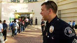 LOS ANGELES, CA - APRIL 21:  Los Angeles School Police Sgt. Robert Carlborn watches over students lining up to pass through a security check point in the aftermath of two apparent racially motivated student brawls at Thomas Jefferson High School April 21, 2005 in Los Angeles, California. A number of students suffered injuries this week while fleeing from a lunch period brawl involving about 200 Latino and African-American students, the second racially charged incident in less than a week. Stepped-up school police and Los Angeles police presence, strict regulation of clothing styles that could be associated with gangs, and a tightened school bell schedule that leaves little time to linger between classes are in effect to curb the violence.  (Photo by David McNew/Getty Images)
