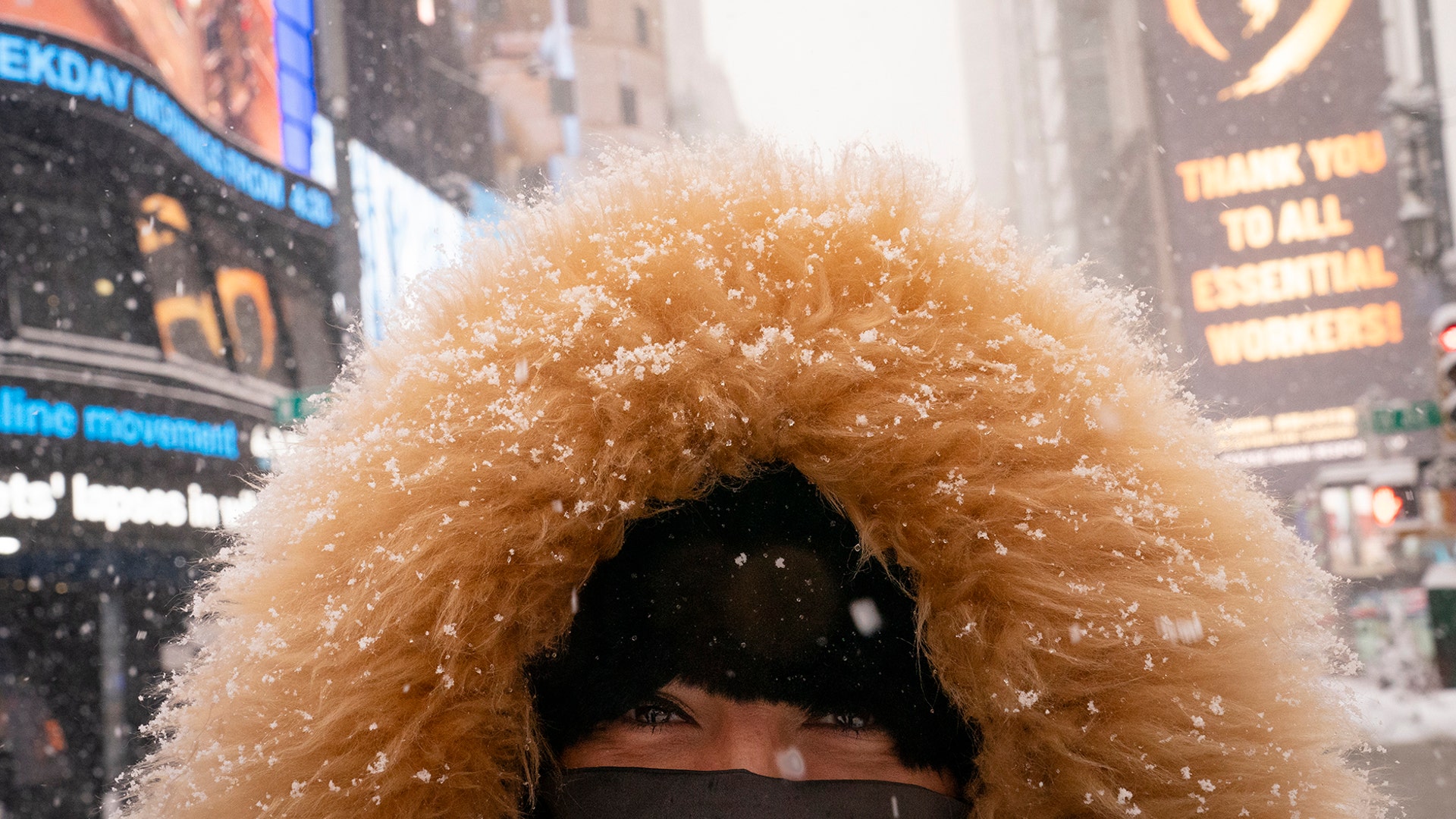 Elinor Fukuda stops in Times Square during a snowstorm, Monday, Feb. 1, 2021, in the Manhattan borough of New York. (AP Photo/John Minchillo)