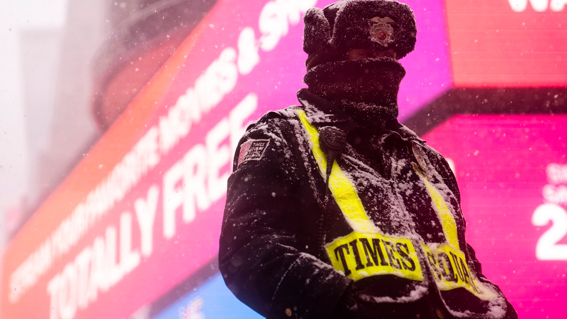 A security guard walks through Times Square during a snowstorm, Monday, Feb. 1, 2021, in the Manhattan borough of New York. (AP Photo/John Minchillo)