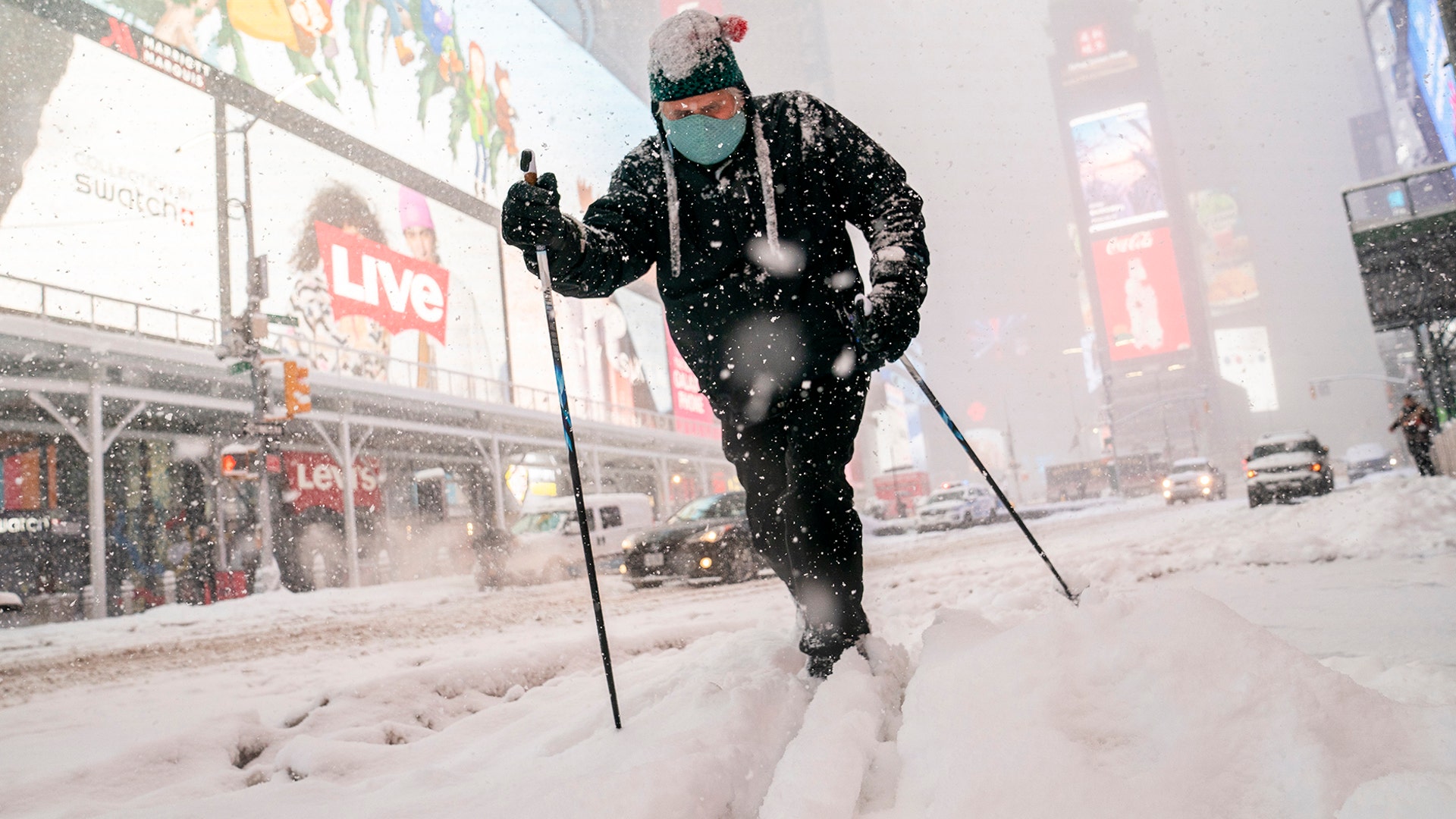Steve Kent skis through Times Square during a snowstorm, Monday, Feb. 1, 2021, in the Manhattan borough of New York. (AP Photo/John Minchillo)