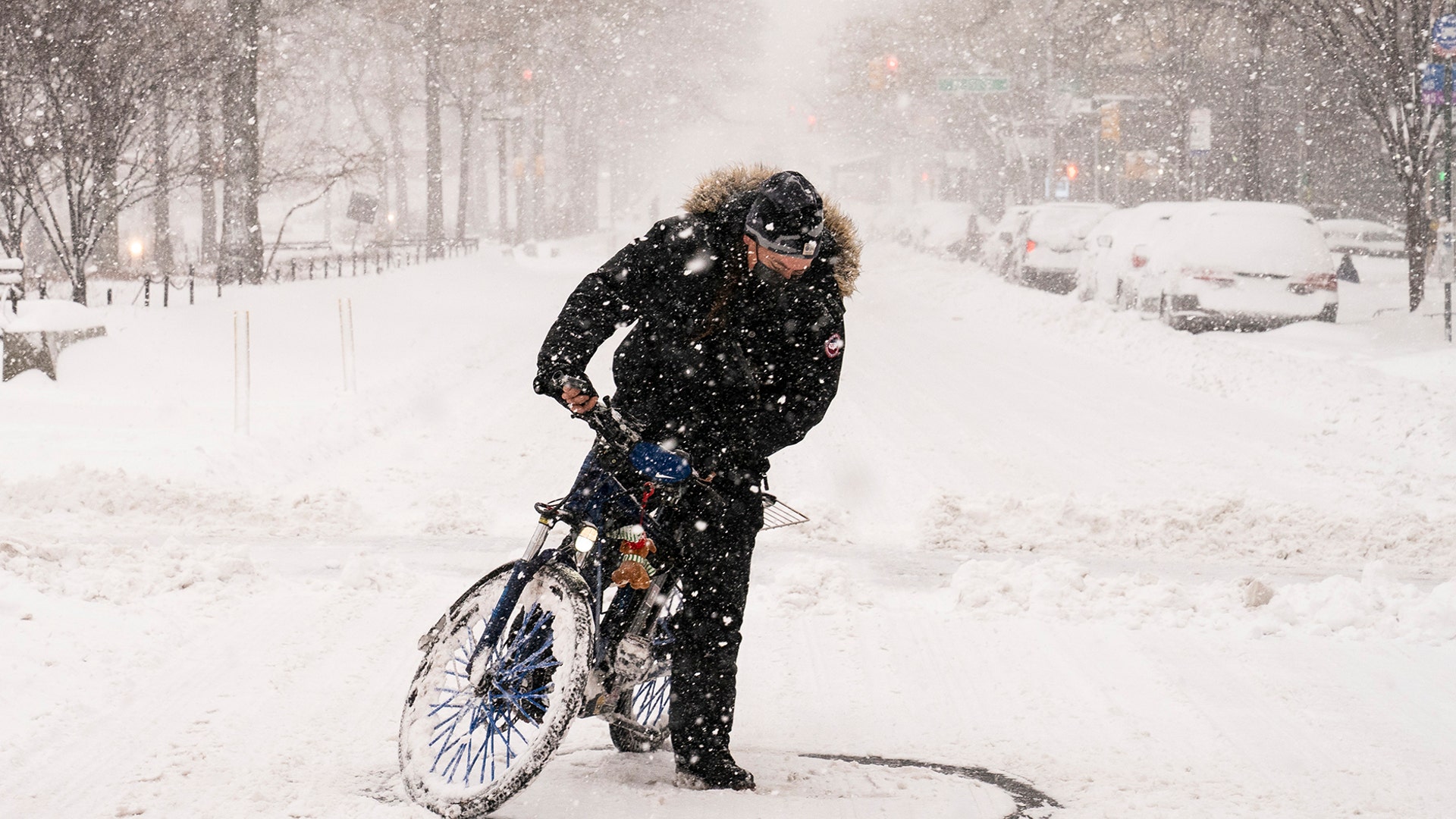 A cyclist on an electric bicycle does donuts on Broadway during a snowstorm, Monday, Feb. 1, 2021, in the Manhattan borough of New York. (AP Photo/John Minchillo)
