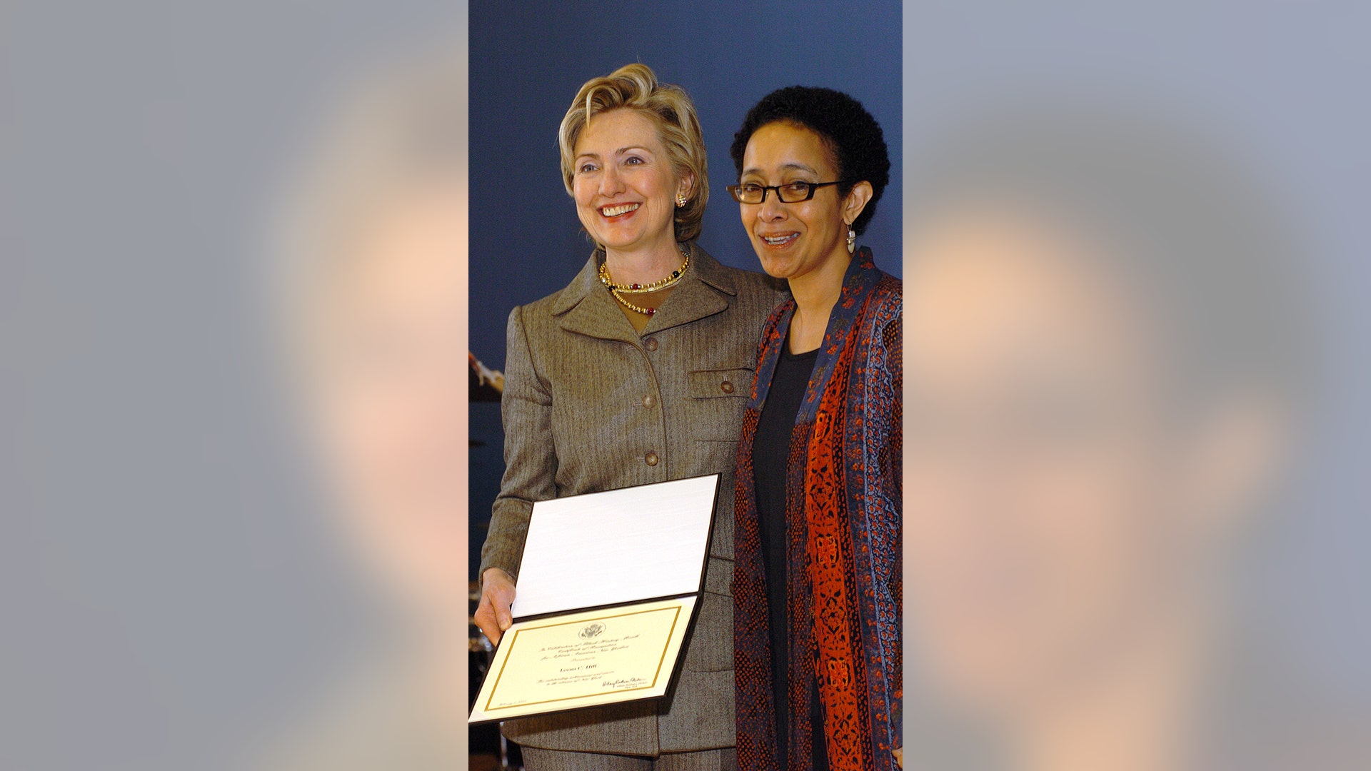 Sen. Hillary Rodham Clinton presents the award to Lorna C. Hill, founder and executive director of the Ujima Company Inc. In celebration of Black History Month, Clinton hosted her fifth annual African American Heritage Celebration in Harlem, New York, honoring several distinguished African American business and community leaders at the Harlem Children's Zone. Clinton joined with President and M.A.C. AIDS Fund Chairman John Demsey to dontate $25,000 to four New York Charities fighting AIDS in the African American community.