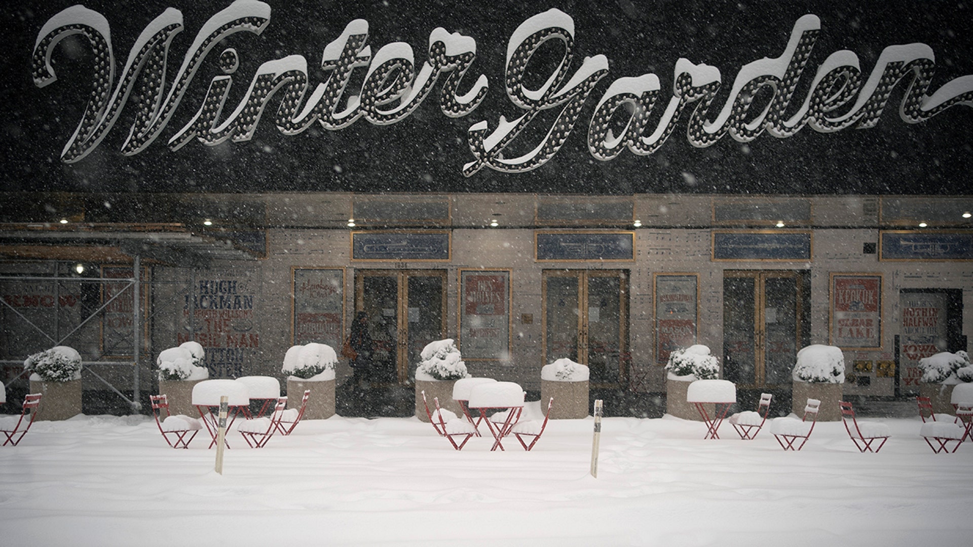 Outdoor dining tables and chairs are covered in snow during a snowstorm, Monday, Feb. 1, 2021, in New York.