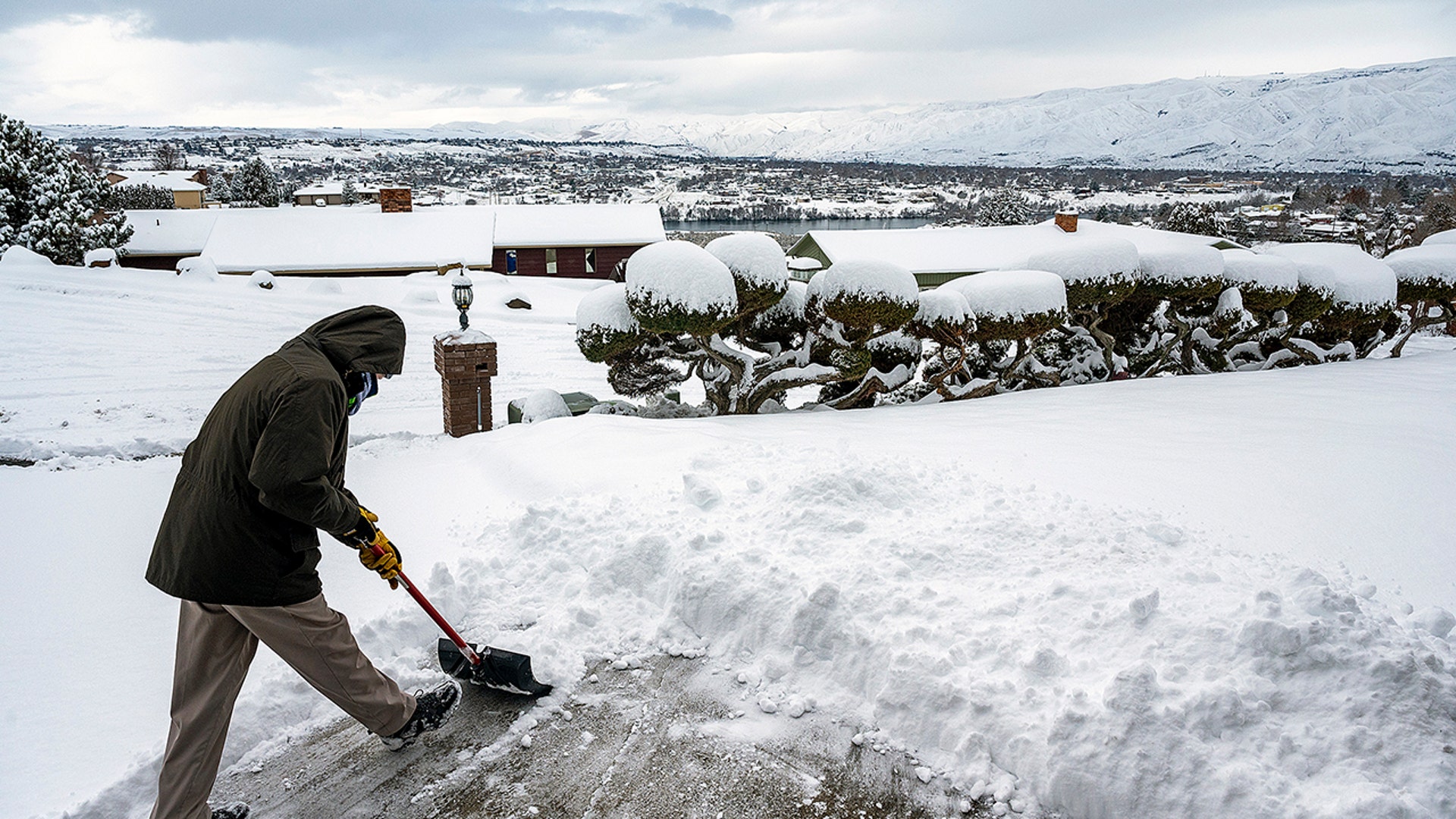 Bob Denny, 73, of Lewiston, shovels off snow from his driveway on the morning of Monday, Feb. 15, 2021, in Lewiston, Idaho. About five inches of snow fell overnight in the Lewiston-Clarkston Valley with more expected throughout Monday and Tuesday.