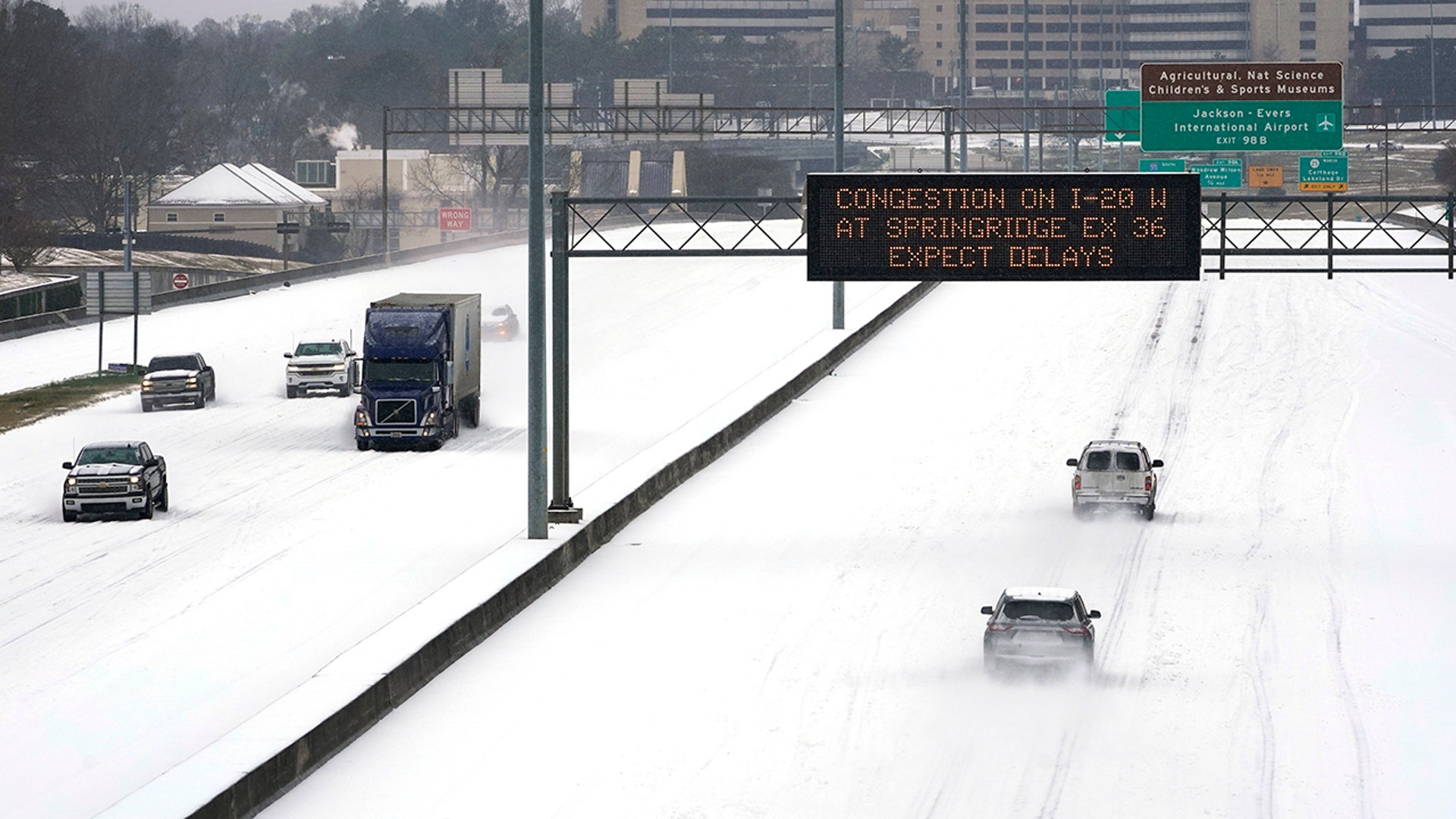 An electronic message board advises drivers of potential congestion on the intersecting interstate as they drive south on Interstate 55 in north Jackson, Miss., Monday, Feb. 15, 2021, as light snow mixed with sleet, and rain continue to cover much of the state. The National Weather Service forecasts temperatures barely hovering at 20 degrees Fahrenheit, and likely slipping into the single digits by Tuesday morning. A winter storm warning continues throughout the state.