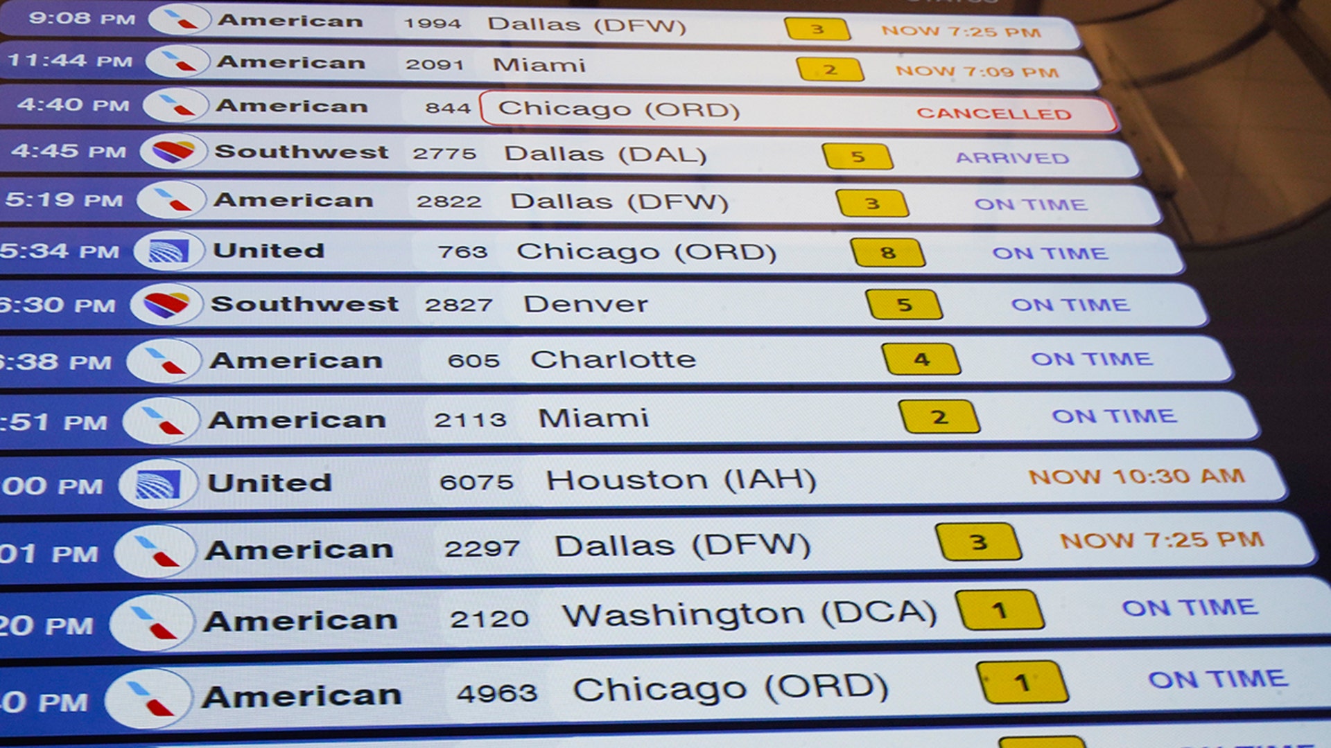 A lighted board shows flights arriving at LaGuardia Airport Tuesday, Feb. 2, 2021, in New York. Tuesday's snowfall comes as residents of the New York City region are digging out from under piles of snow that shut down public transport, canceled flights and closed coronavirus vaccination sites.