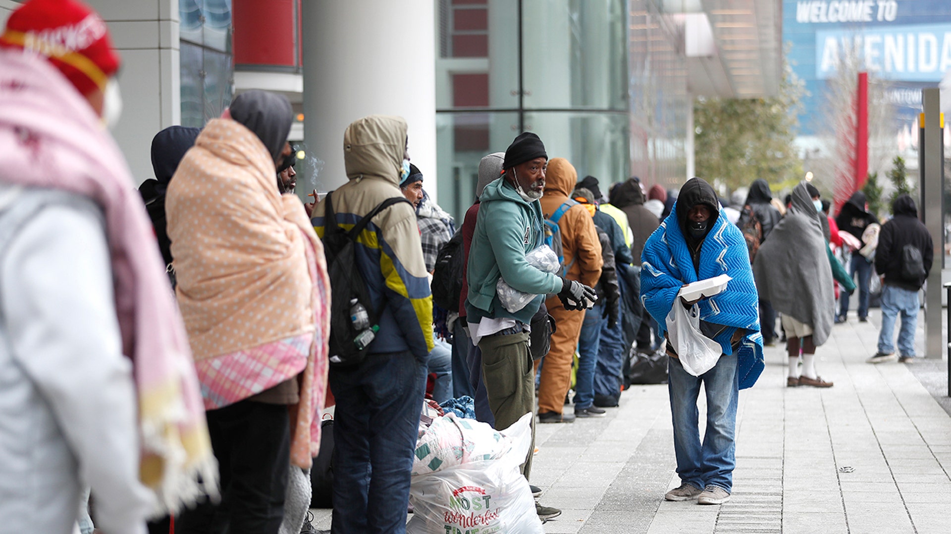 A line of more than 200 people formed outside the George R. Brown Convention Center in Houston, Sunday, Feb. 14, 2021, which city officials opened as an emergency shelter for the area homeless, who needed to get out of the freezing temperatures.