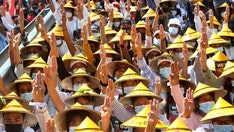 Protests swell after Burma junta raises specter of force