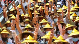 Protests swell after Burma junta raises specter of force