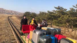 Russian diplomats exit North Korea by hand-pushed trolley