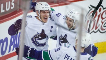 Boeser leads Canucks past Flames in last of 4 straight games