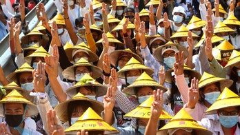 Protests swell after Burma junta raises specter of force