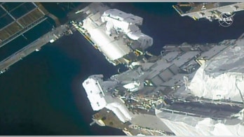 Spacewalking astronauts prep station for new solar wings