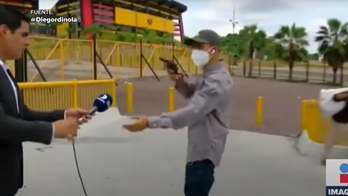 Gun-waving robber holds up TV reporter, crew while filming in Ecuador