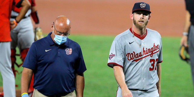 Stephen Strasburg walks towards the dugout