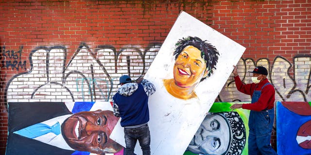 Artists installed a painting of Stacey Abrams in the Historic King District on Monday, January 18, 2021, in honor of Martin Luther King Jr. Day, in Atlanta. 