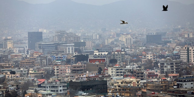 Birds fly over the city of Kabul, Afghanistan, Sunday, Jan. 31, 2021. (AP Photo/Rahmat Gul)