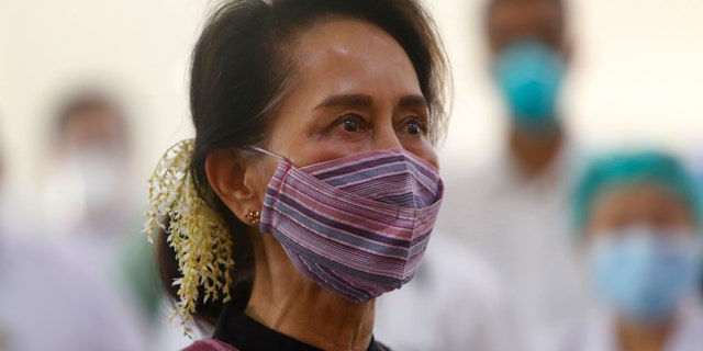 FILE - In this Jan 27, 2021, file photo, Myanmar leader Aung San Suu Kyi watches the vaccination of health workers at hospital in Naypyitaw, Myanmar. Reports says Monday, Feb. 1, 2021 a military coup has taken place in Myanmar and Suu Kyi has been detained under house arrest. (AP Photo/Aung Shine Oo, File)