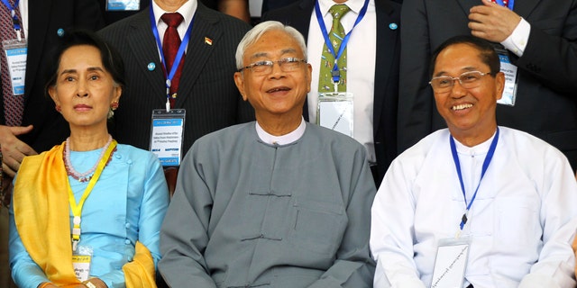 FILE - In this May 24, 2017, file photo, Myanmar's Vice President Myint Swe, right, smiles while sitting with State Counsellor Aung San Suu Kyi, left, and then President Htin Kyaw during a photo session after the second session of the 21st Century Panglong Union Peace Conference at the Myanmar International Convention Center in Naypyitaw, Myanmar. (AP Photo/Aung Shine Oo, File)