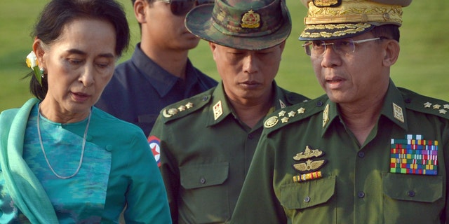 In this May 6, 2016, file photo, Aung San Suu Kyi, left, Burma's foreign minister, walks with senior General Min Aung Hlaing, right, Burma military's commander-in-chief, in Naypyitaw, Burma. (AP Photo/Aung Shine Oo, File)