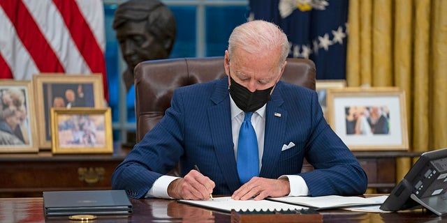 President Joe Biden signs an executive order on immigration at the White House, Feb. 2, 2021. (AP Photo/Evan Vucci)
