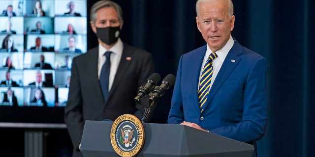 Secretary of State Antony Blinken listens as President Joe Biden delivers remarks to State Department staff, Thursday, Feb. 4, 2021, in Washington. (AP Photo/Evan Vucci)