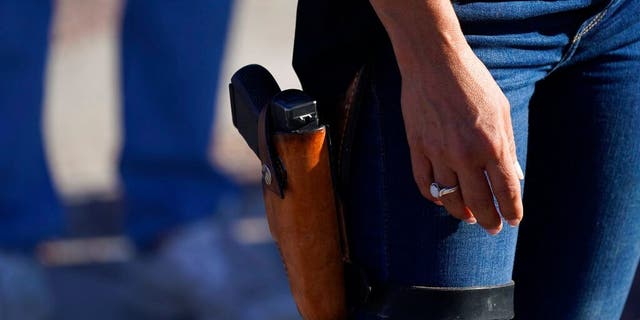 Lauren Boebert, then-Republican candidate for the U.S. House of Representatives seat in Colorado's vast 3rd Congressional District, carries a gun during a freedom cruise staged by her supporters in Pueblo West, Colo., Sept. 4, 2020. (Associated Press)