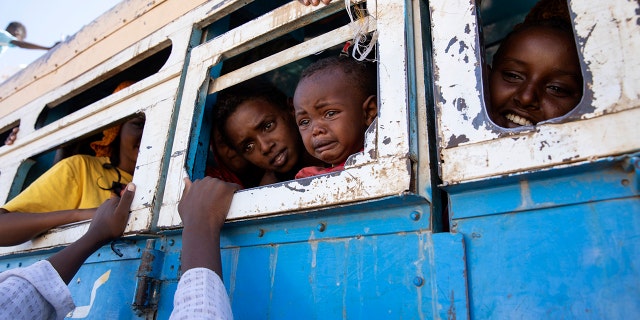 Refugees fleeing the conflict in Ethiopia's Tigray region ride a bus going to the Village 8 temporary shelter, near the Sudan-Ethiopia border, in Hamdayet, eastern Sudan, Dec. 1, 2020. (Associated Press)