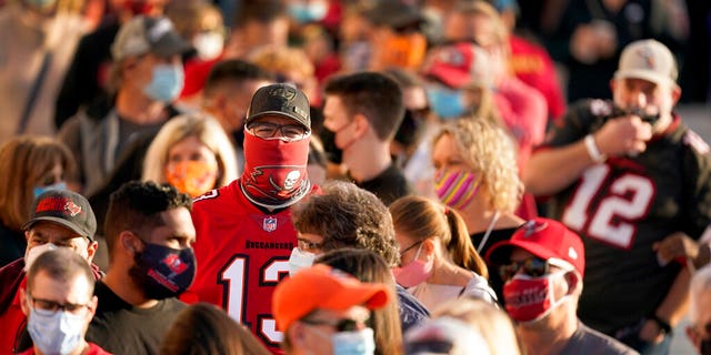 In this Feb. 4, 2021, file photo, people wait in line for an exhibit at the NFL Experience in Tampa, Fla. The city is hosting Sunday's Super Bowl football game between the Tampa Bay Buccaneers and the Kansas City Chiefs. (AP Photo/Charlie Riedel, File)