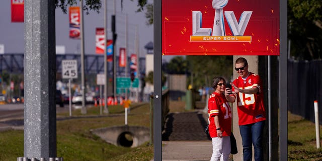 In this Feb. 4, 2021, file photo, Kansas City Chiefs fans take a selfie outside of Raymond James Stadium ahead of Super Bowl 55 in Tampa, Fla. (AP Photo/Charlie Riedel, File)