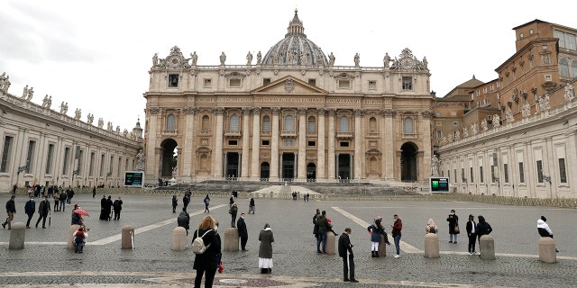 Faithful gather as they wait for Pope Francis to recite the Angelus prayer from his studio window overlooking St. Peter's Square, at the Vatican, Sunday, Feb. 7, 2021. (AP Photo/Gregorio Borgia)