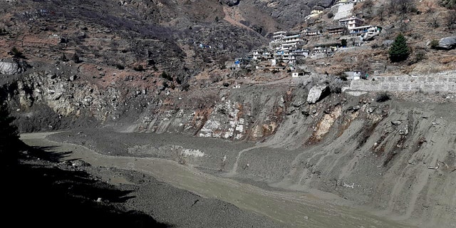 Mud and slash are seen in the Dhauliganga River after a portion of Nanda Devi glacier broke off in Tapovan area of the northern state of Uttarakhand, Sunday, Feb.7, 2021. (AP Photo)