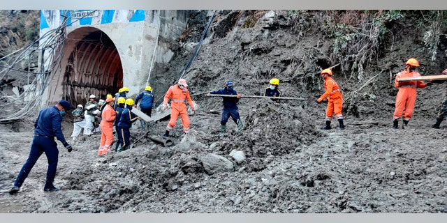 This photograph provided by National Disaster Response Force shows NDRF personnel prepare to rescue workers at one of the hydropower project at Reni village in Chamoli district of Indian state of Uttrakhund, Monday, Feb. 8, 2021. Rescue efforts continued on Monday to save 37 people after part of a glacier broke off, releasing a torrent of water and debris that slammed into two hydroelectric plants on Sunday. (National Disaster Response Force via AP)