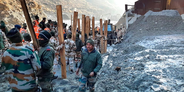 Indo Tibetan Border Police (ITBP) personnel undertake rescue work at one of the hydro power project at Reni village in ​​Chamoli district, in Indian state of Uttrakhund, Monday, Feb.8, 2021. Rescue efforts continued on Monday to save 37 people after part of a glacier broke off, releasing a torrent of water and debris that slammed into two hydroelectric plants on Sunday. (AP Photo)