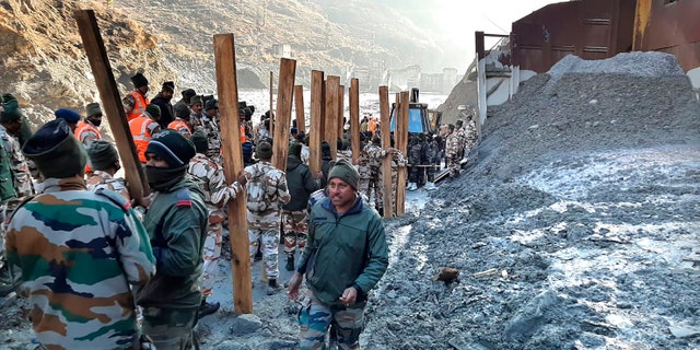 Indo Tibetan Border Police (ITBP) personnel undertake rescue work at one of the hydro power project at Reni village in ​​Chamoli district, in Indian state of Uttrakhund, Monday, Feb.8, 2021. Rescue efforts continued on Monday to save 37 people after part of a glacier broke off, releasing a torrent of water and debris that slammed into two hydroelectric plants on Sunday. (AP Photo)